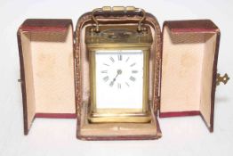 Gilt metal four glass carriage clock with enamel dial in leather case.