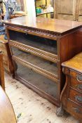 Early 20th Century mahogany bookcase having hinged top above three drop down glazed panel doors,