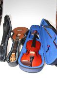 The Stentor Student 1 violin with bow, cased, and a child's guitar in case.