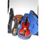 The Stentor Student 1 violin with bow, cased, and a child's guitar in case.