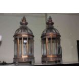 Pair of metal and glazed hanging lanterns, approximately 62cm high.