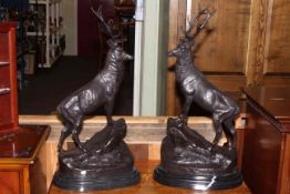 Pair of impressive bronze stags on rocky outcrops, 74cm high.