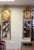 Pair rectangular gilt framed portrait bevelled wall mirrors with ornate swag and floral crests,