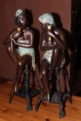 Two metal semi-nude lady sculptures.