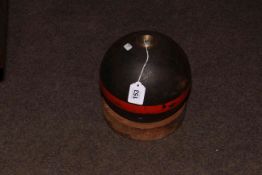 Iron canon ball on wooden mount.