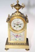 Gilt metal mantel clock with bird and floral dial and panel.