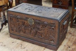 Oriental carved camphorwood trunk, 59.5cm by 111cm by 52cm.