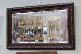 Rectangular framed bevelled wall mirror marked Cadbury's, 54.5cm by 90cm.