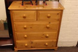 Pine chest of two short above three long drawers on bun feet, 91cm by 90cm by 45cm.