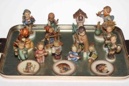 Collection of fourteen Hummel figures and three small plates.