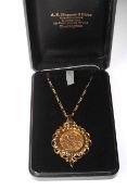 Gold half sovereign in 9 carat gold pendant mount on link chain.