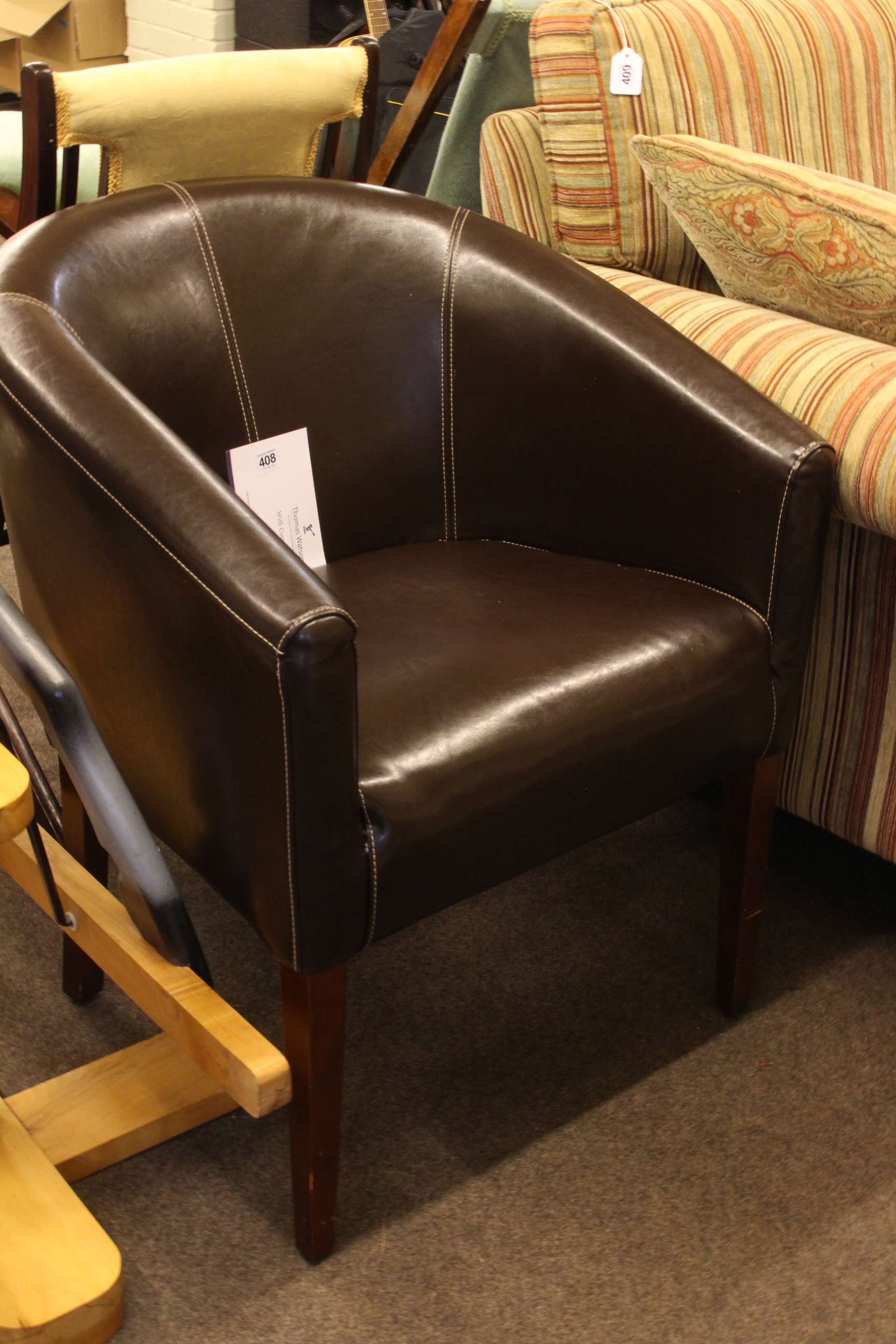 Chocolate brown stitched leather? club chair.