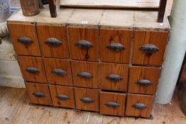 Bank of fifteen pitch pine drawers, 73cm by 91cm by 61cm.