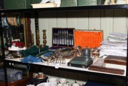 Collection of cased cutlery, linens, brass candle holders, etc.