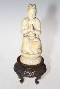 Antique Chinese ivory figure on carved wood stand, 29.5cm overall height.