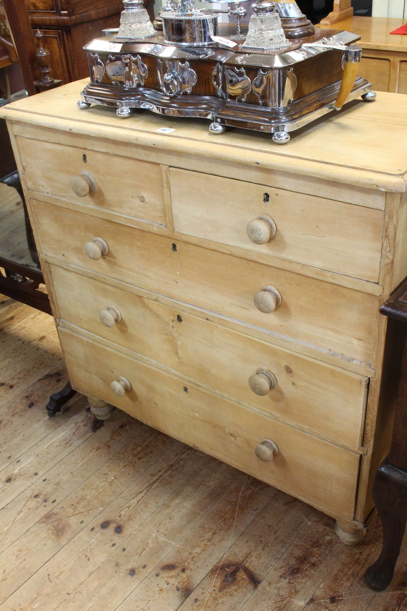 Stripped pine chest of two short above three long drawers on turned legs, 96cm by 98cm by 44cm.