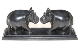 Pair carved elephants on plinth base, 26cm across.