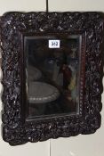 Indian intricately carved hardwood mirror, 38cm by 32cm including frame.