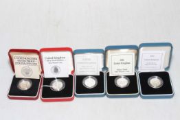 Five Royal Mint United Kingdom silver proof one pound coins with boxes and COAs.