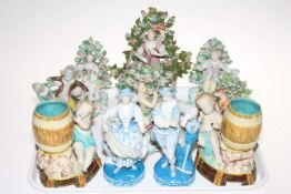 Five Continental bocage figures, two putti and barrel vases, contest group and pair figures (10).