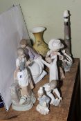 Five Lladro pieces including Bird and Floral vase, and three Nao figurines and a table lamp.