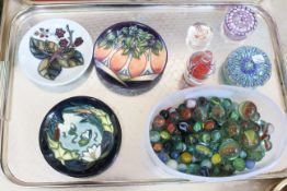 Millefiori and other glass paperweights, tub of marbles and three Moorcroft pin trays.