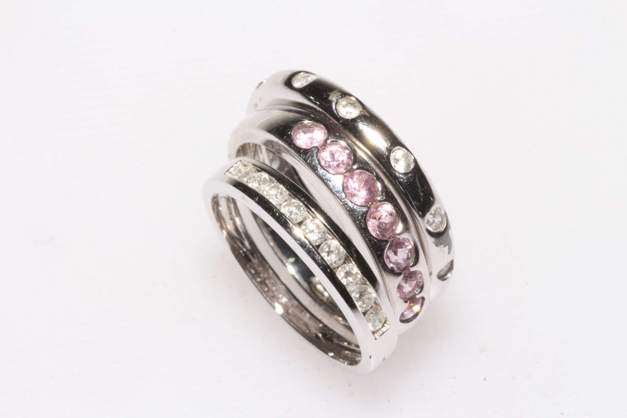 Two 9 carat white gold rings and a sterling silver ring (3).