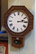 Octagonal carved oak wall clock.