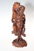 Chinese carved wood figure of male drinking from vessel, 35cm.