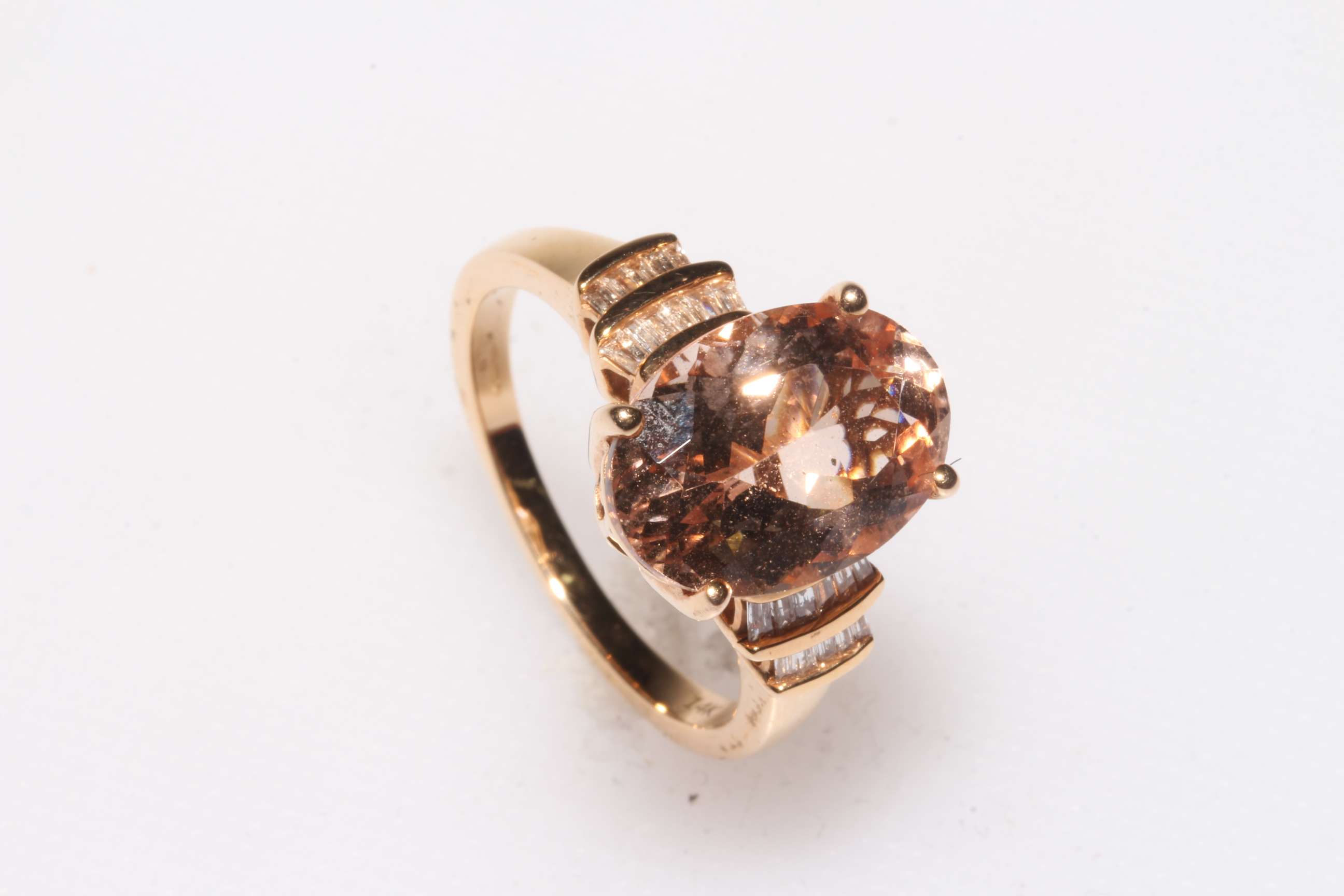 14 carat yellow gold 5 carat oval Morganite ring set with baguette diamonds to each shoulder with