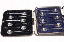 Two cased sets of silver bean coffee spoons.
