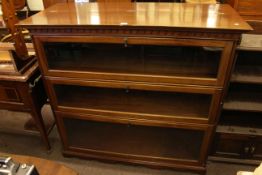 Early 20th Century mahogany bookcase having hinged top above three drop down glazed panel doors,