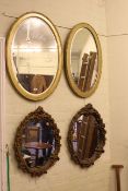 Pair oval gilt framed bevelled wall mirrors and pair oval gilt plaster framed wall mirrors (4).