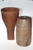 Wooden stick stand and wickerwork waste bin.