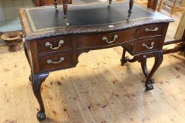 Early 20th Century mahogany Chippendale style five drawer serpentine front writing table on ball