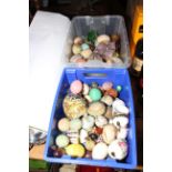 Two boxes of precious stones, glass and other eggs.