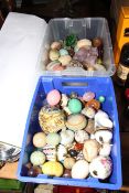 Two boxes of precious stones, glass and other eggs.