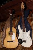 Vintage acoustic guitar and Peavey electric guitar.