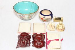 Small collection of Oriental items including famille rose bowl, two netsuke, masks, needle holders,