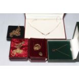 9 carat gold jewellery comprising boxed necklace, garnet pendant, diamond pendant and three chains.