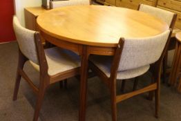 Teak circular extending dining table and four chairs.