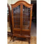 Edwardian mahogany arched top four drawer cabinet bookcase on ball and claw legs,
