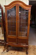 Edwardian mahogany arched top four drawer cabinet bookcase on ball and claw legs,