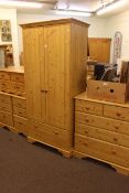 Pine finish five piece bedroom suite comprising two door combination wardrobe, five drawer chest,