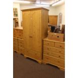 Pine finish five piece bedroom suite comprising two door combination wardrobe, five drawer chest,