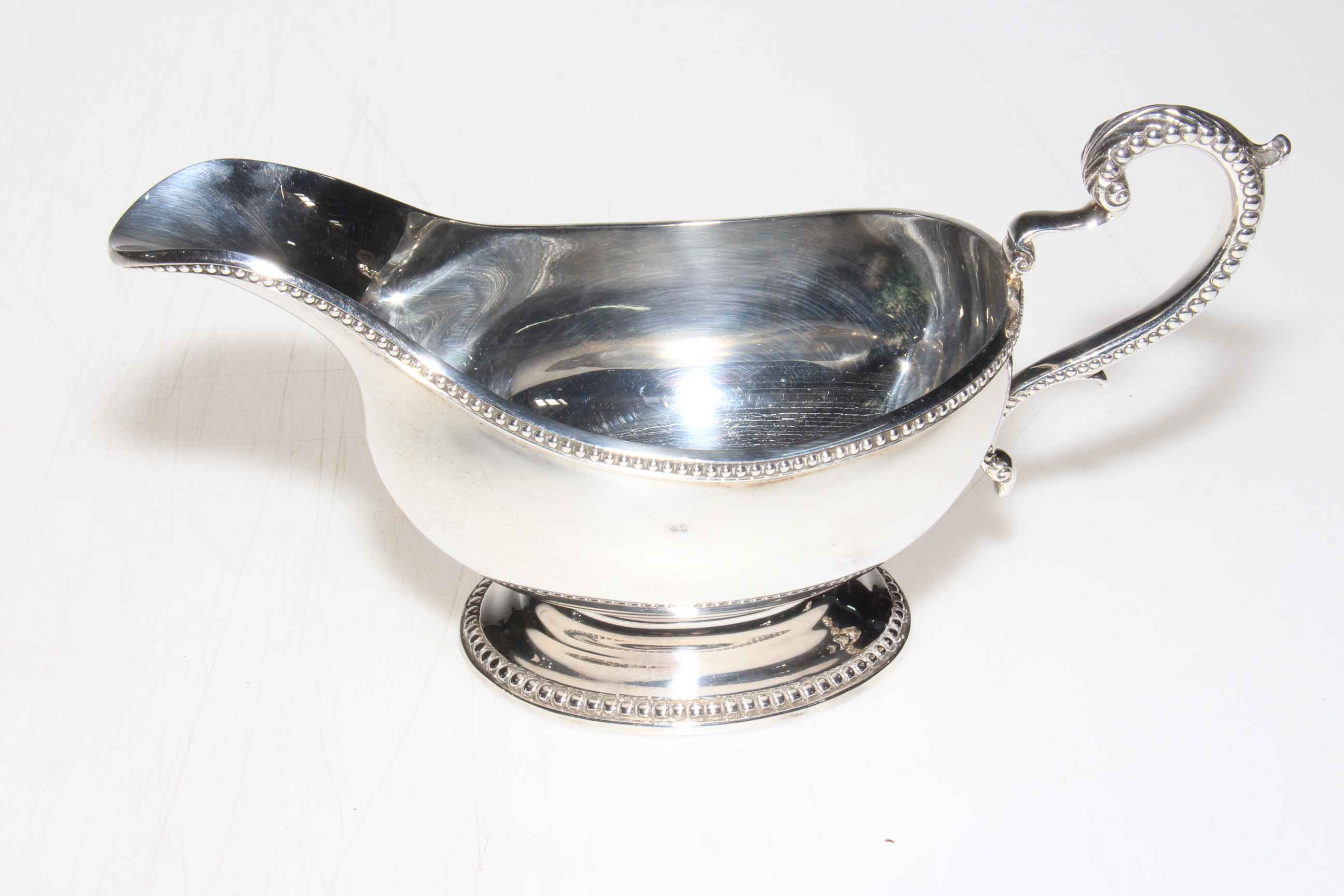 Silver sauce boat with beaded handle and borders, London 1968.