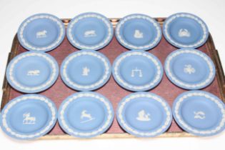 Set of twelve Wedgwood Blue Jasperware plates each depicting the Signs of the Zodiac, 11cm diameter.