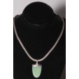 Silver rope chain with green stone pendant.