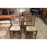 Set of six Country style rush seated ladder back dining chairs including pair carvers.