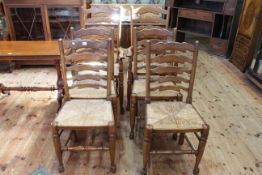 Set of six Country style rush seated ladder back dining chairs including pair carvers.